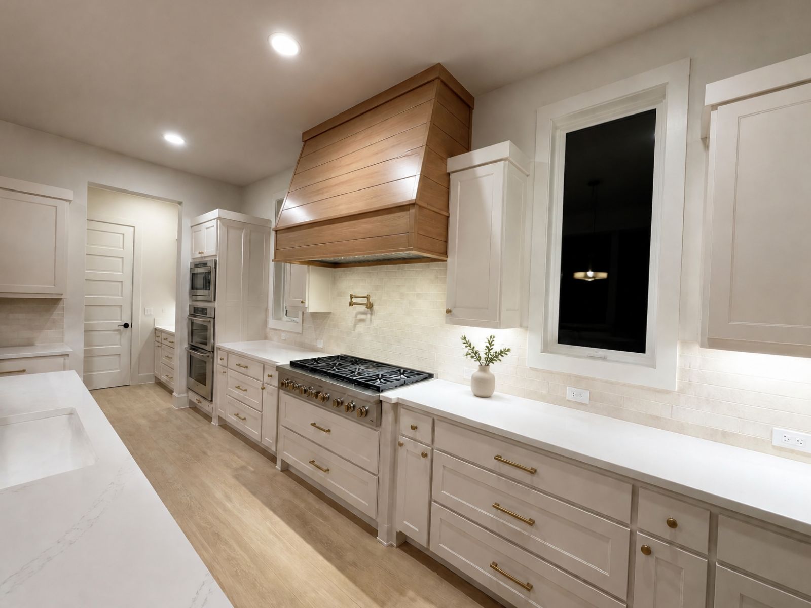 Custom kitchen with shiplap range hood and brass hardware